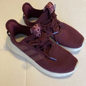 Maroon woman’s Adidas sneakers
